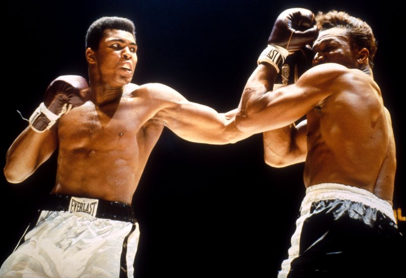 Muhammad Ali throws lead hook